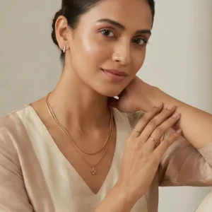 Modern Indian working woman wearing minimalist anti-tarnish gold necklace and earrings for office - Virelle Jewellery