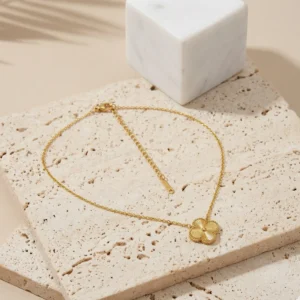 Myra delicate anti-tarnish steel chain necklace featuring a gold-tone textured clover pendant for regular use
